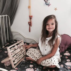 dziewczynka i zabawki drewniane do nauki czytania i pisania